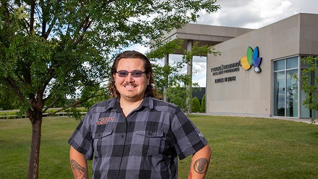 Logan Grigsby stands in front of the Student Center